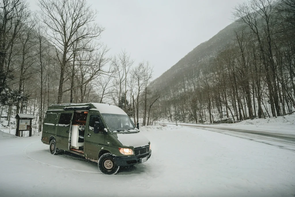 A high-roof cargo van equipped with a  spacious and cozy van life set-up.