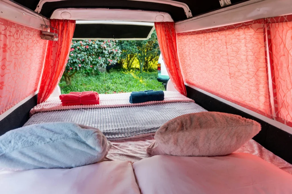 A cozy bed setup inside a minivan.